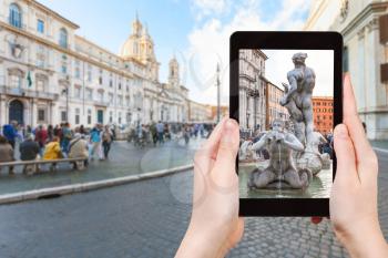 travel concept - tourist photographs fountain on piazza Navona in Rome city on tablet in Italy