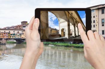 travel concept - tourist photographs vasari corridor in Florence city on tablet in Italy