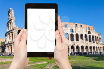 travel concept - tourist photographs Coliseum in Rome city on tablet with cut out screen with blank place for advertising in Italy