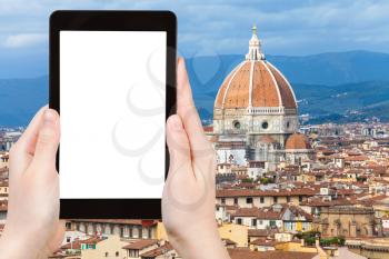 travel concept - tourist photographs Cathedral Santa Maria del Fiore in Florence city on tablet with cut out screen with blank place for advertising in Italy