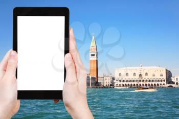 travel concept - tourist photographs Venice skyline on tablet with cut out screen with blank place for advertising in Italy