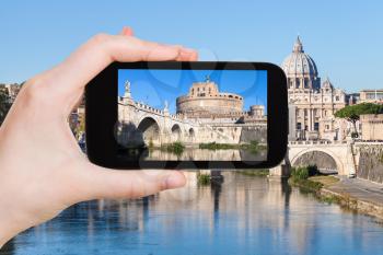 travel concept - tourist photographs Castel Sant Angelo (Holy Angel Casle) in Rome city on smartphone in Italy