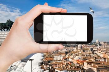 travel concept - tourist photographs Rome city on smartphone with cut out screen with blank place for advertising in Italy