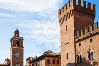 travel to Italy - clock tower and tower of City Hall in Ferrara city