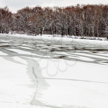 spring season - melting ice on frozen river