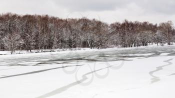 spring season - melting ice surface of frozen river