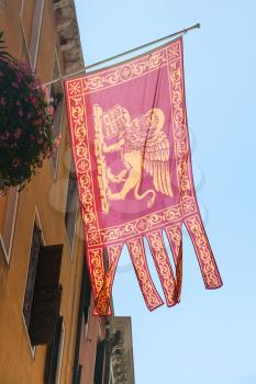travel to Italy - flag of republic of Venice (Most Serene Republic) on urban house