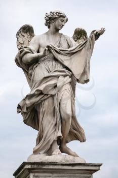 Travel to Italy - figure of Angel (Angel with the Sudarium, Veronica's Veil, by Cosimo Fancelli) on Ponte Sant Angelo in Rome city in winter