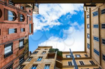 Travel to Italy - bottom view of cloudy sky from pation of urban house in Rome city in winter
