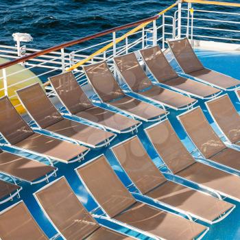 above view of empty chairs in sunbathing area on stern of cruise liner
