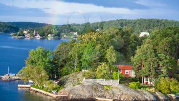 above view of country house in green woods on rocky coast of Baltic Sea sunny autumn day, Sweden