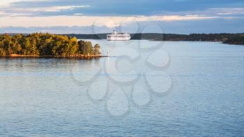 view of cruise liner and coastline of Baltic Sea in autumn sunset, Sweden