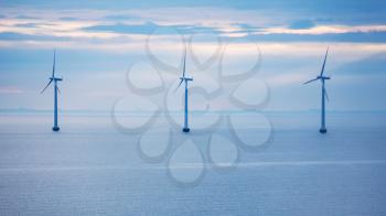 Travel to Denmark - turbines of offshore wind farm Middelgrunden in Oresund near Copenhagen city in Baltic Sea in blue autumn morning