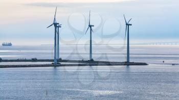 Travel to Denmark - turbines on ground of offshore wind farm Middelgrunden in Oresund near Copenhagen city in Baltic Sea in blue autumn morning