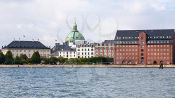 Travel to Denmark - waterfront with edifice of The Royal Cast Collection at the West India Warehouse and view of dome of Marble Church (Frederik's Church, Marmorkirken) in Copenhagen city in autumn