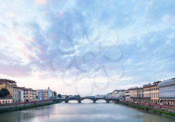 travel to Italy - blue clouds over Arno River with Ponte alla Carraia bridge in Florence city in evening twilight