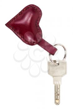 door key with red leather heart shape keychain isolated on white background