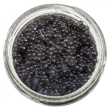 top view of black coloured pickled caviar of halibut fish in glass jar isolated on white background