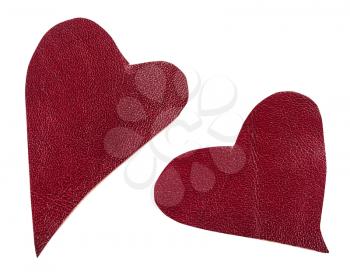 two cut out red leather hearts isolated on white background