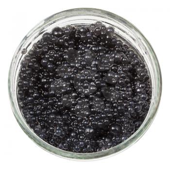 above view of black dyed salty caviare of halibut fish in glass jar isolated on white background