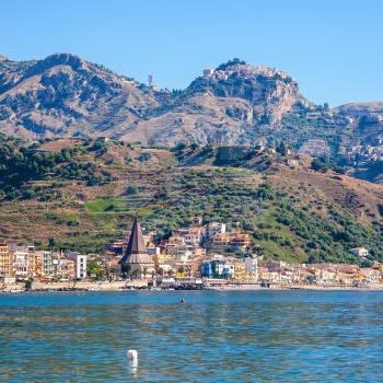 travel to Italy - view of Taormina city on mountain and Giardini Naxos town on the coast of Ionian sea in Sicily in summer day