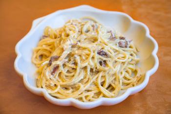 travel to Italy, italian cuisine - spaghetti alla carbonara on plate in Sicily