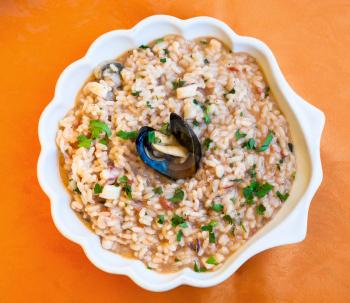 travel to Italy, italian cuisine - top view of Risotto al mare on plate in Sicily