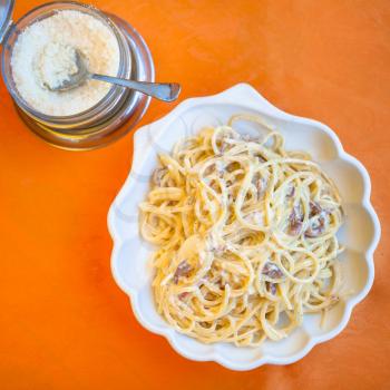 travel to Italy, italian cuisine - top view of spaghetti alla carbonara on plate in Sicily