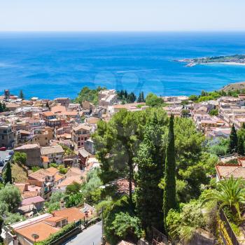 travel to Italy - above view of Taormina town from Castelmola village in Sicily in summer day