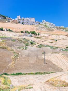 travel to Italy - agrarian fields and ruins in southern Sicily in summer day