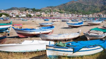travel to Italy - boats on urban beach in resort village Giardini Naxos in Sicily
