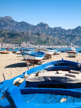 travel to Italy - boats on urban beach in Giardini Naxos town in Sicily