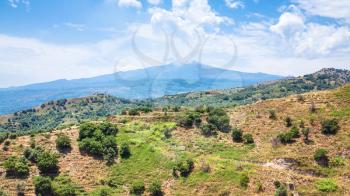 travel to Italy - view of Etna mount and green mountain slope near Calatabiano town in Sicily
