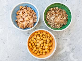 top view of three kind of cold breakfast cereals in bowls on table