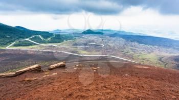 travel to Italy - road in frozen lava fields on Mount Etna in Sicily in summer day