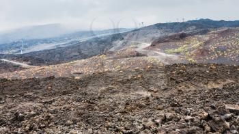 travel to Italy - view of hardened lava field and cableway on Mount Etna in Sicily in summer day