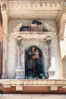 travel to Italy - Sculpture of a Saint in niche of an urban house in Venice city