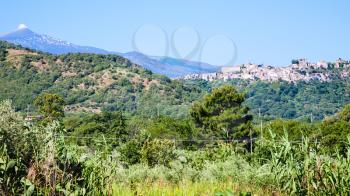 travel to Italy - view of countryside in Sicily with green gardens, Etna mountain, Castiglione di Sicilia town