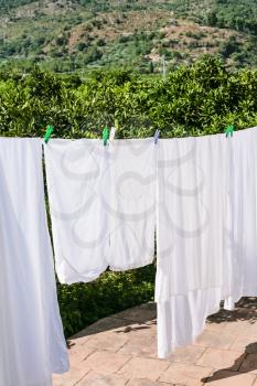 agricultural tourism in Italy - drying linen on open backyard in Sicily in summer day