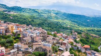 travel to Italy - above view of urban houses of Castiglione di Sicilia town and mountain valley in Sicily