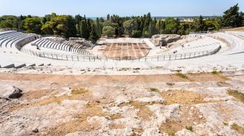 travel to Italy - above view of ancient Greek theater in Archaeological Park (Parco Archeologico della Neapolis) of Syracuse city in Sicily
