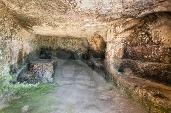 travel to Italy - room in artificial cave of ancient Greek theater in Archaeological Park (Parco Archeologico della Neapolis) of Syracuse city, Sicily