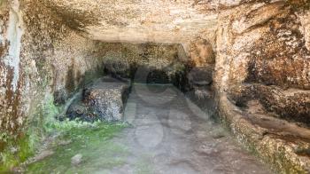 travel to Italy - interior in artificial cave of ancient Greek theater in Archaeological Park (Parco Archeologico della Neapolis) of Syracuse city, Sicily