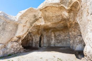 travel to Italy - hall in artificial cave of ancient Greek theater in Archaeological Park (Parco Archeologico della Neapolis) of Syracuse city, Sicily