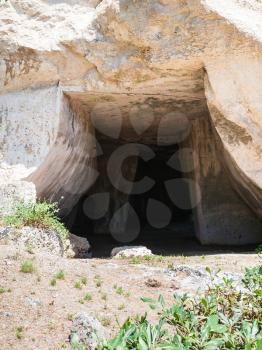 travel to Italy - entrance to Grotta dei Cordari (Rope-makers Cave) in Temenites Hill in Latomie del Paradiso area of Archaeological Park of Syracuse city in Sicily