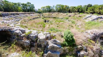 travel to Italy - ancient roman Amphitheatre (Anfiteatro romano di Siracusa) in Archaeological Park (Parco Archeologico della Neapolis) of Syracuse city in Sicily