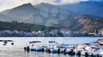 GIARDINI NAXOS, ITALY - JULY 6, 2011: boat mooring in Giardini Naxos town in evening. Naxos was founded by Thucles the Chalcidian in 734 BC, and since 1970s it has become a seaside-resort