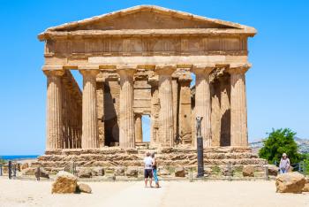 AGRIGENTO, ITALY - JUNE 29, 2011: tourists near Tempio della Concordia in Valley of the Temples in Sicily. This area has largest and best-preserved ancient Greek buildings outside of Greece itself