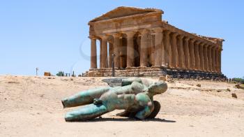 AGRIGENTO, ITALY - JUNE 29, 2011: sculpture and Temple of Concordia in Valley of the Temples in Sicily. This area has largest and best-preserved ancient Greek buildings outside of Greece itself