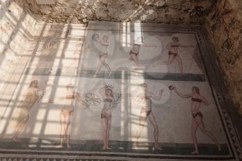PIAZZA ARMERINA, ITALY - JUNE 29, 2011: Bikini girls mosaic in pool of Villa Romana del Casale. This ancient villa was built in the 4th century and located near Piazza Armerina town in Sicily